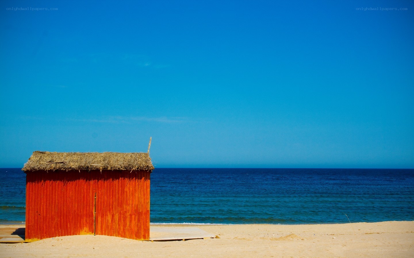 Red beach hut by the sea