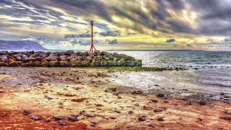 Red Beacon on Rocky Shore