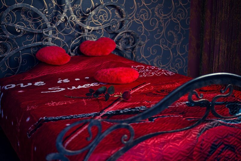 Red Bed with Heart Pillows
