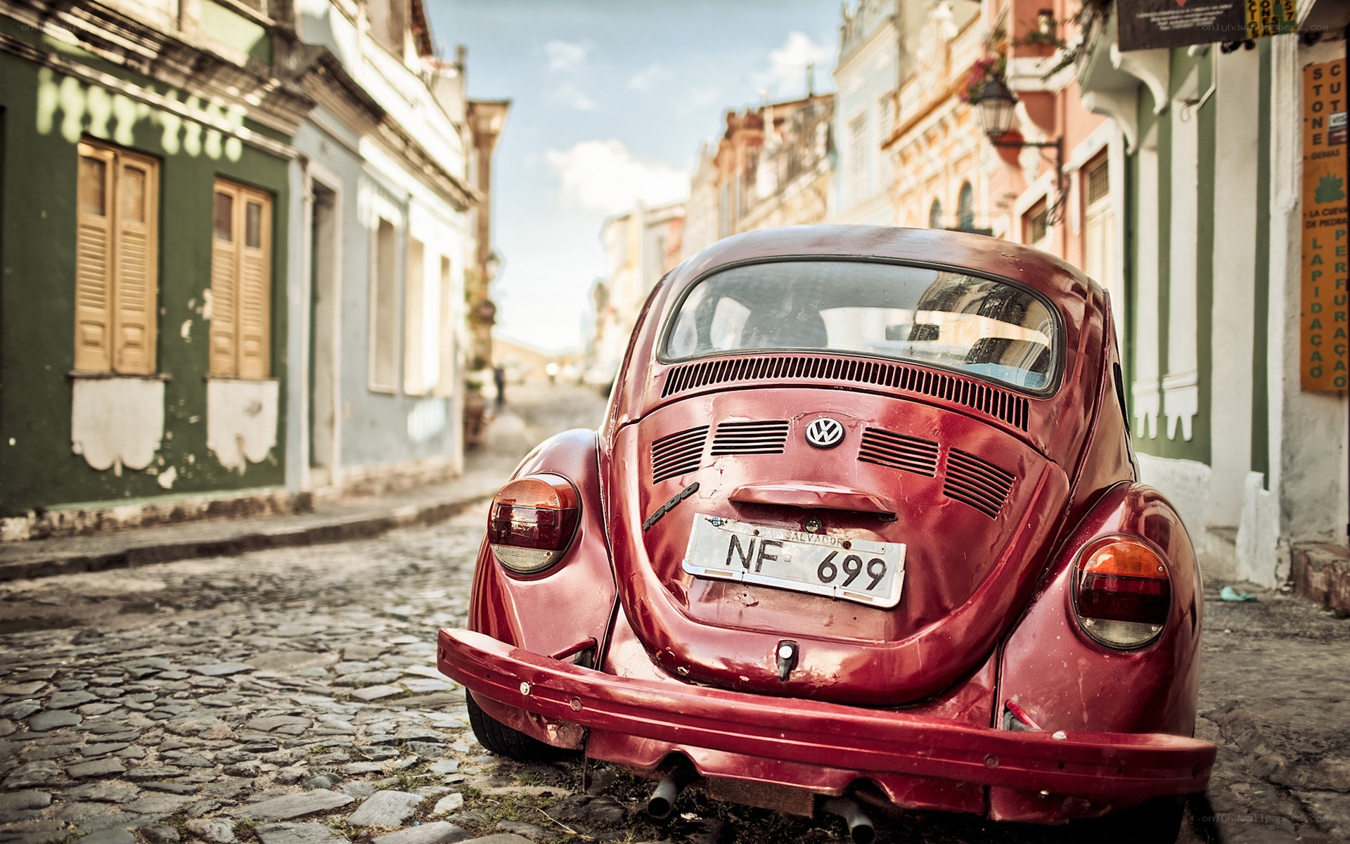 Red Beetle on a cobblestone street