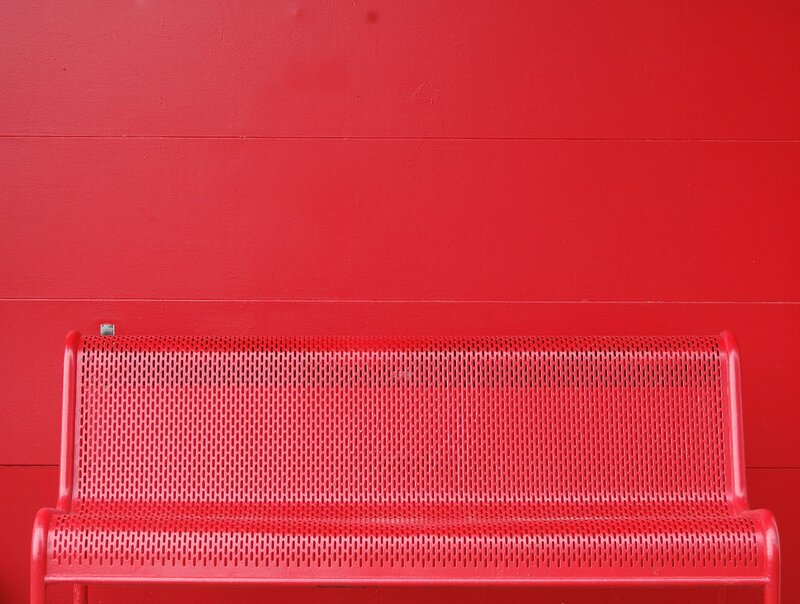 Red bench against red wall