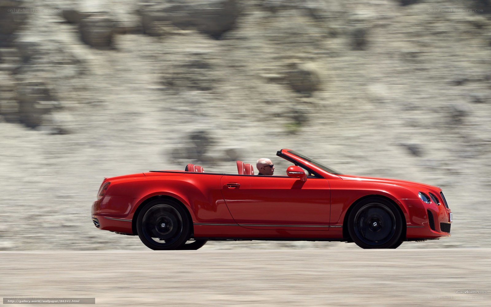 Red Bentley convertible in motion