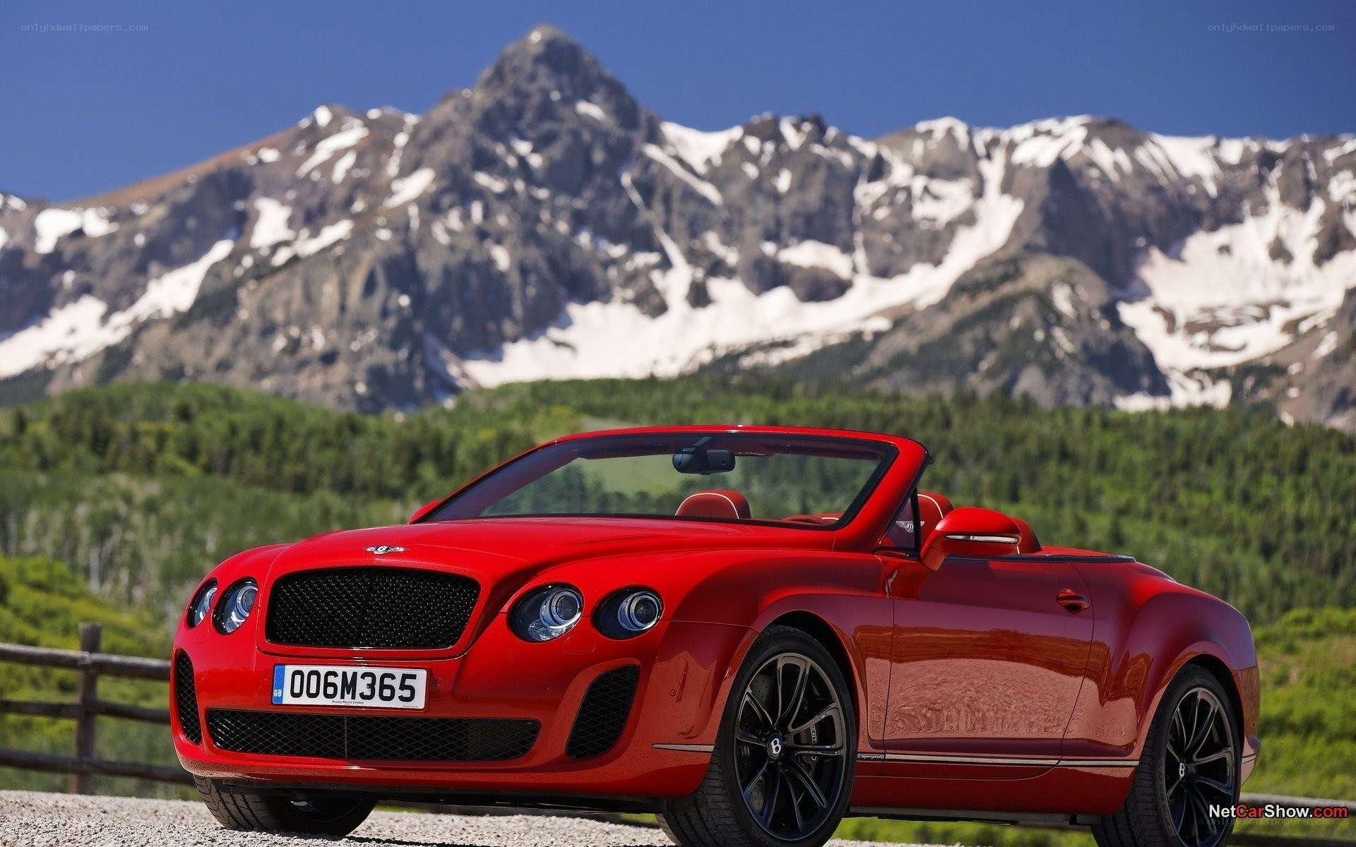 Red Bentley convertible in mountains