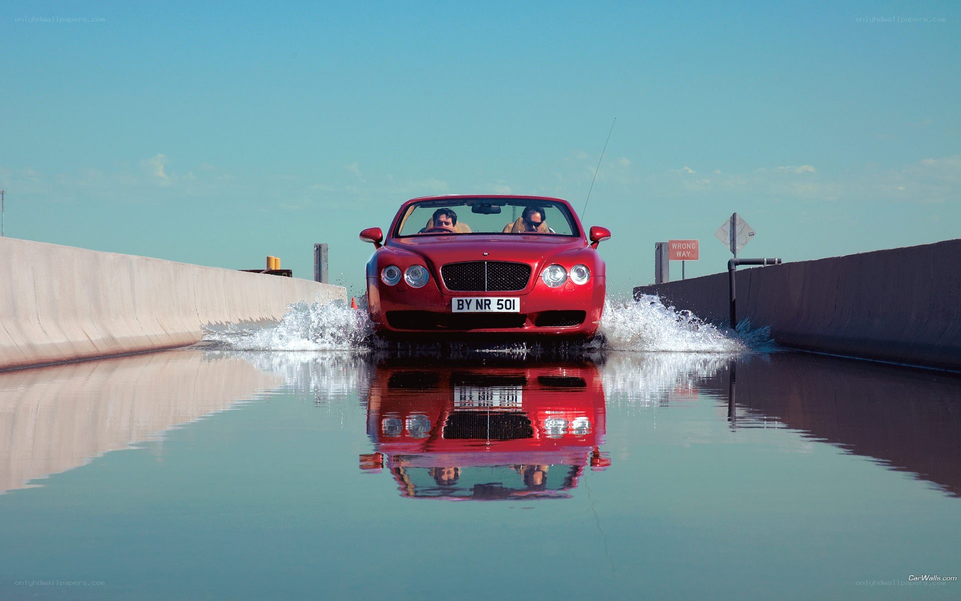 Red Bentley convertible in water