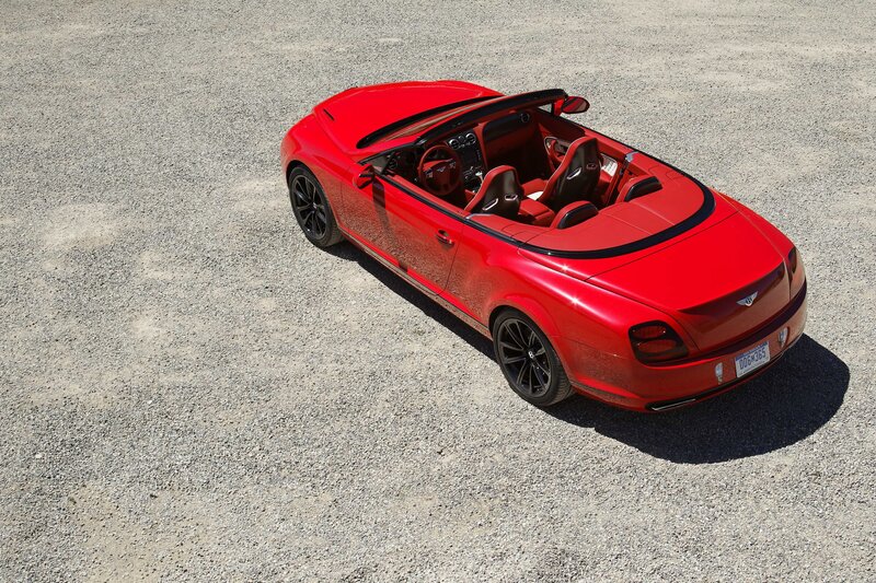 Red Bentley convertible on gravel