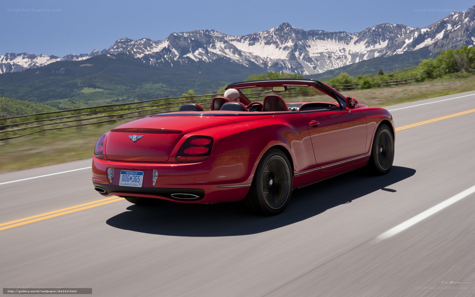 Red Bentley convertible on mountain road