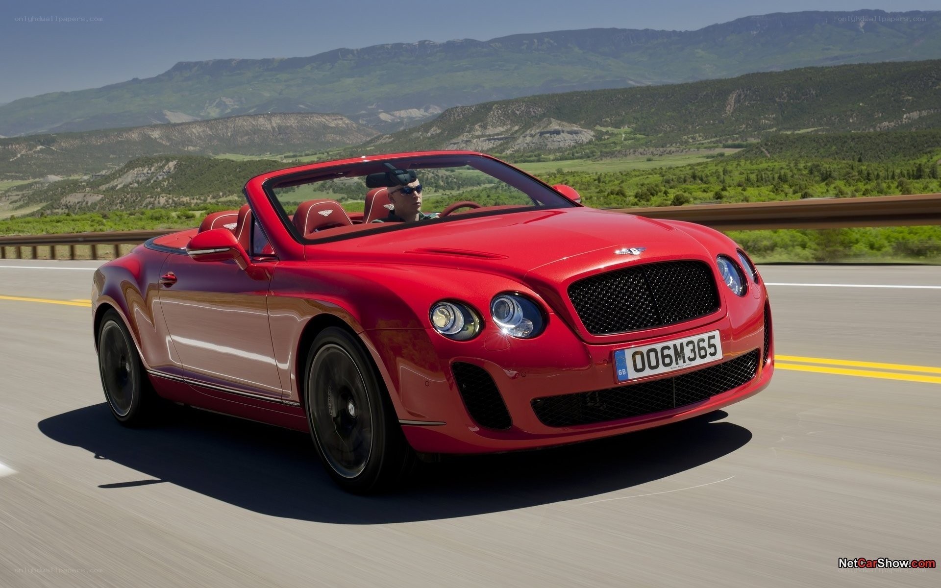 Red Bentley convertible on road