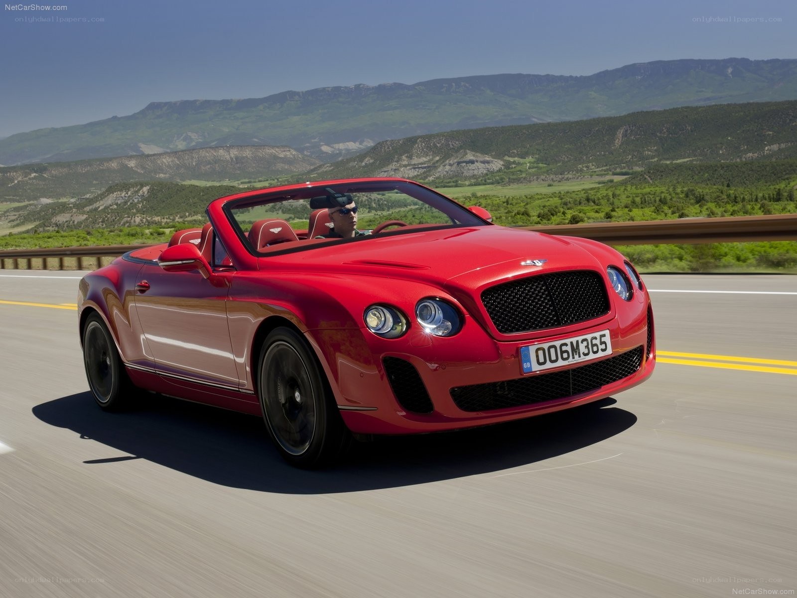 Red Bentley convertible on road
