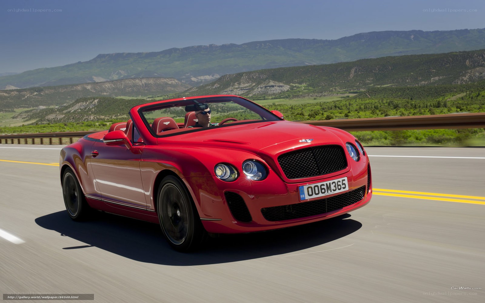 Red Bentley convertible on road