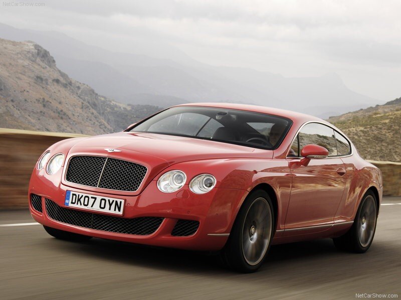 red bentley coupe on mountain road