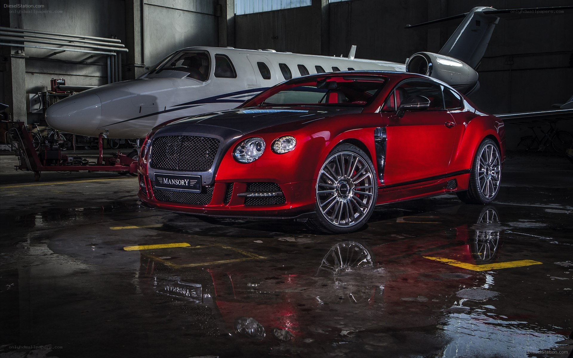 Red Bentley in hangar with private jet