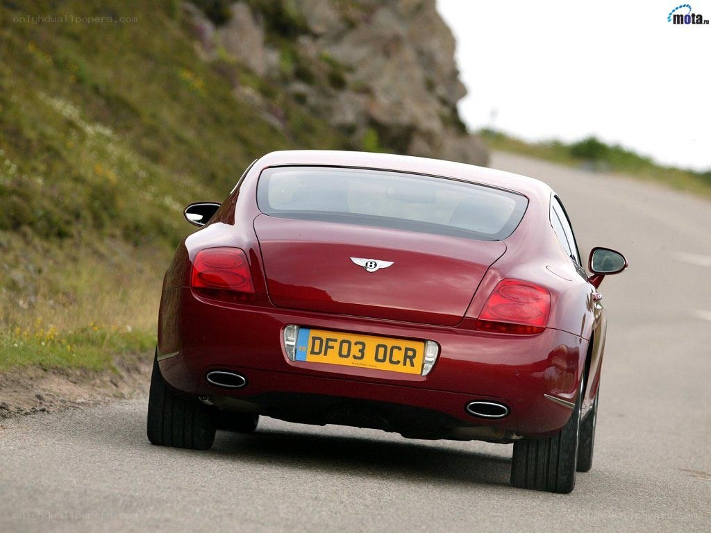 red bentley on a winding road