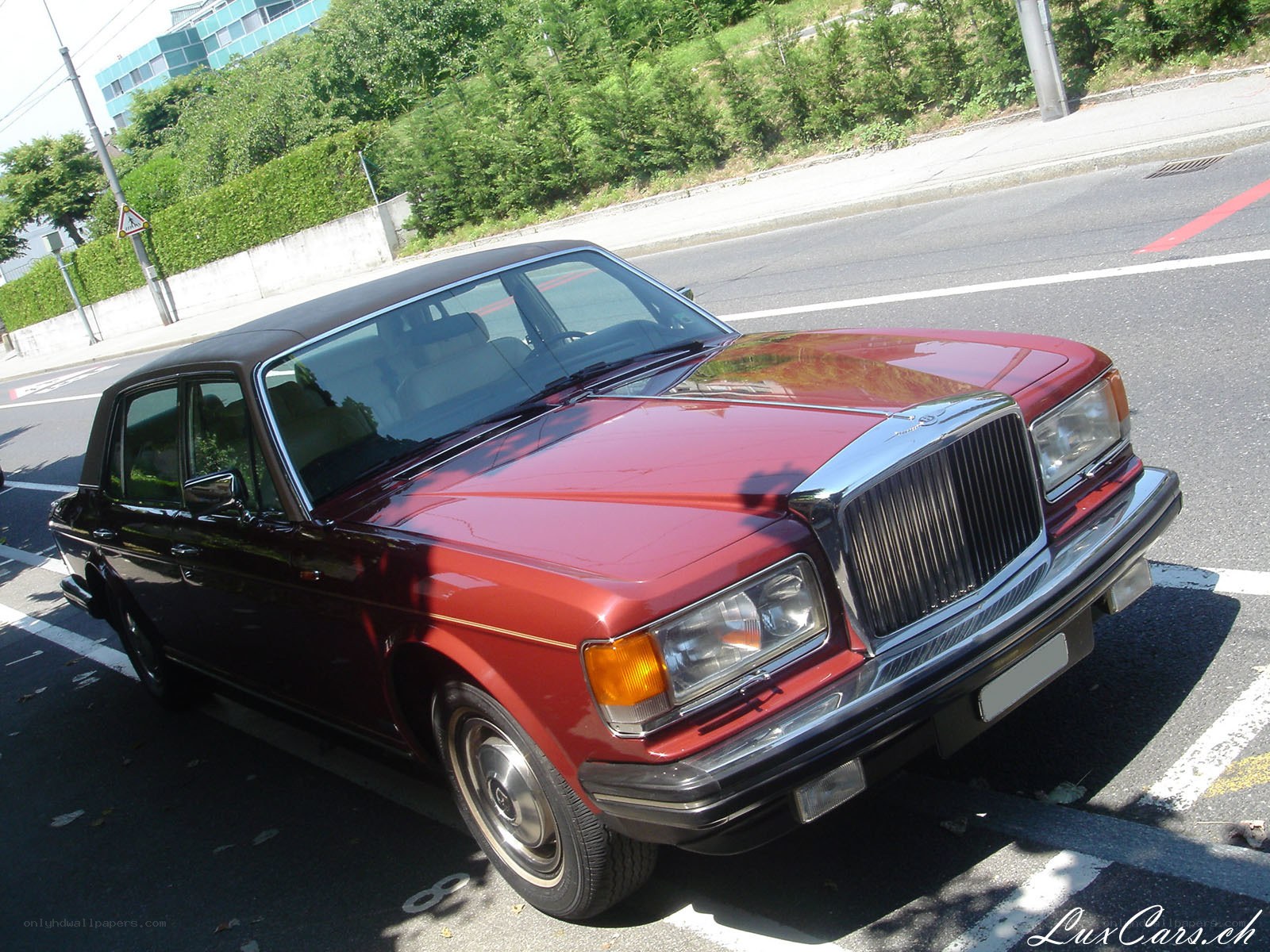Red Bentley parked on street