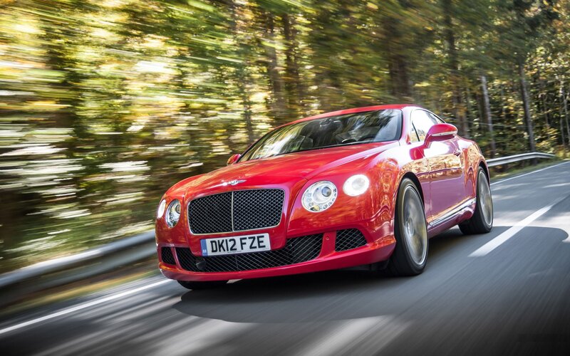 Red Bentley speeding on a road