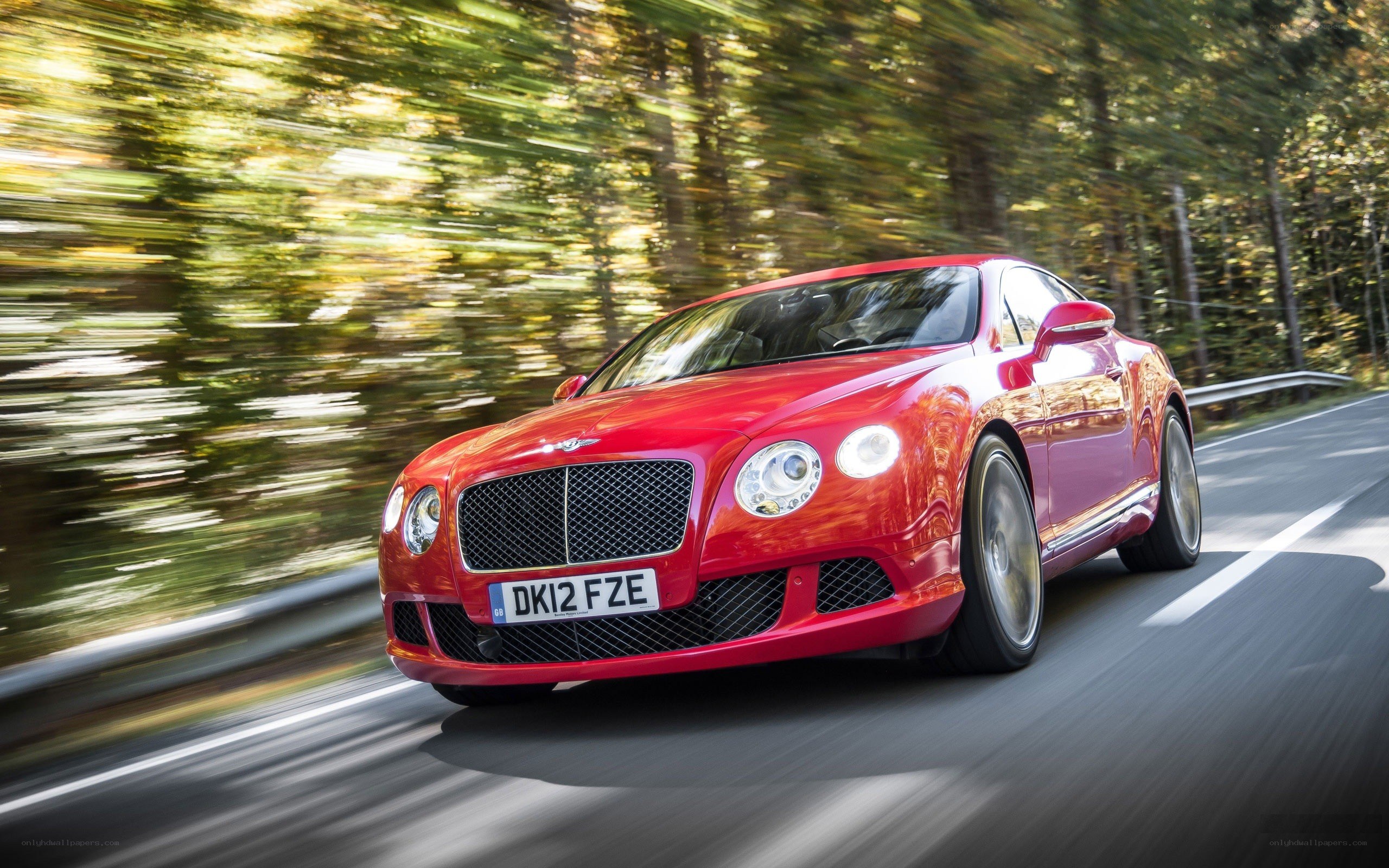 Red Bentley speeding on a road