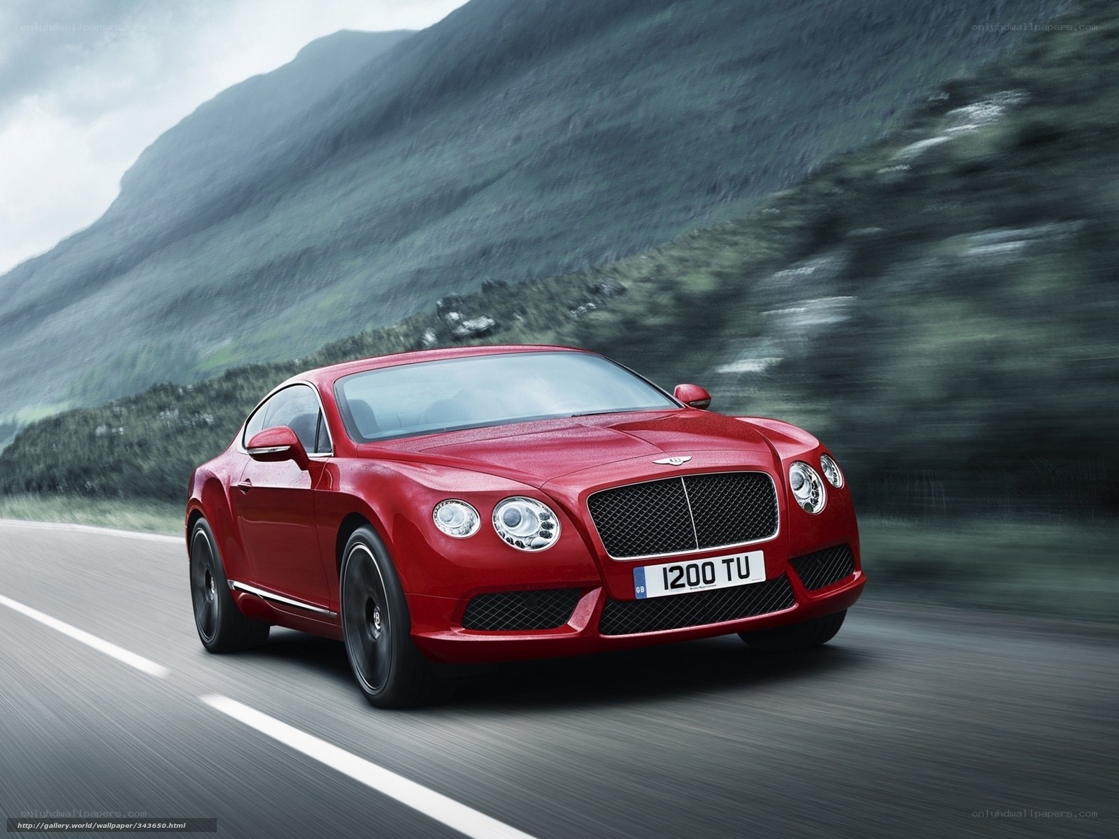 Red Bentley speeding on mountain road