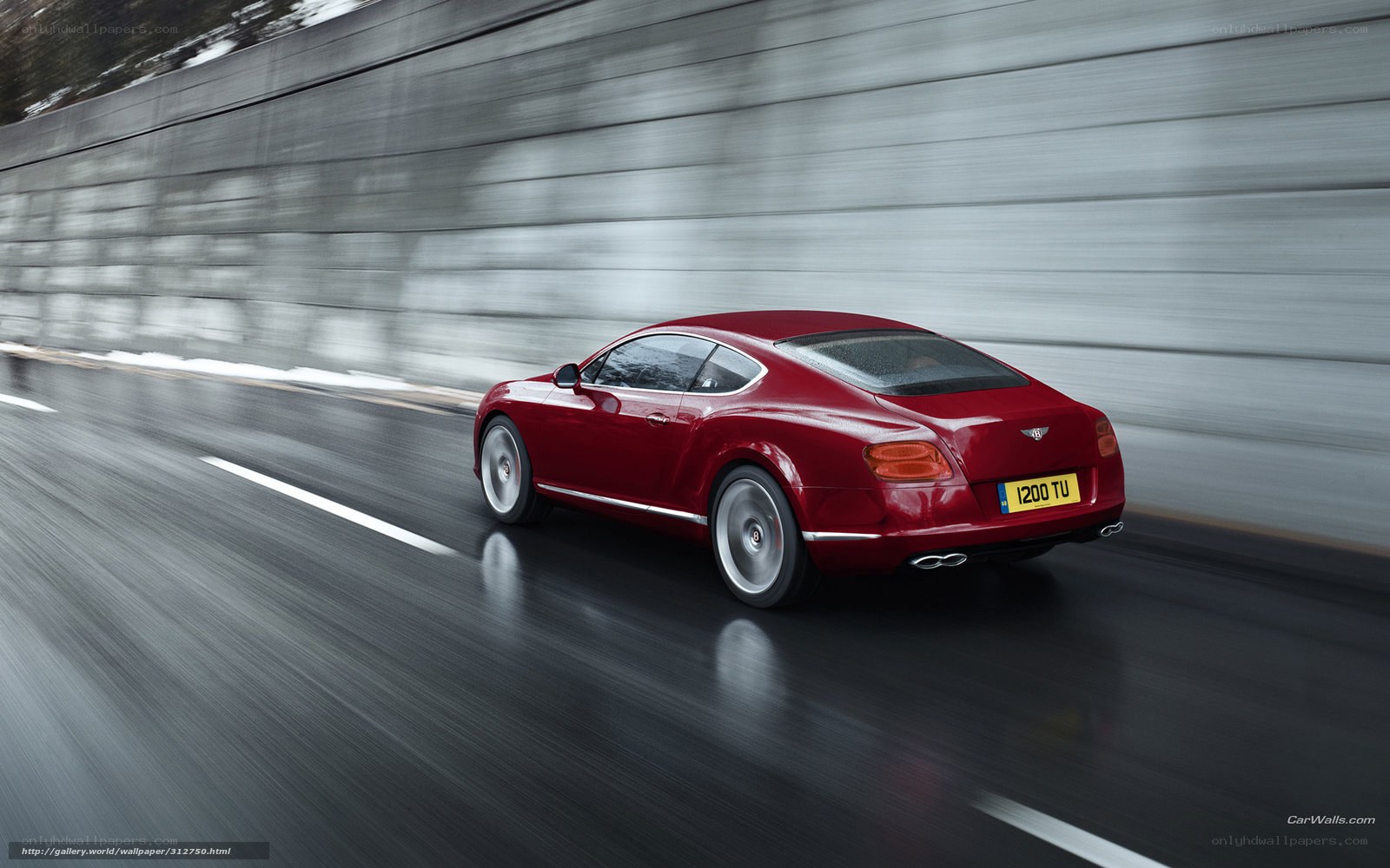 Red Bentley speeding on wet road