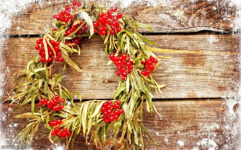 Red berry wreath on wood