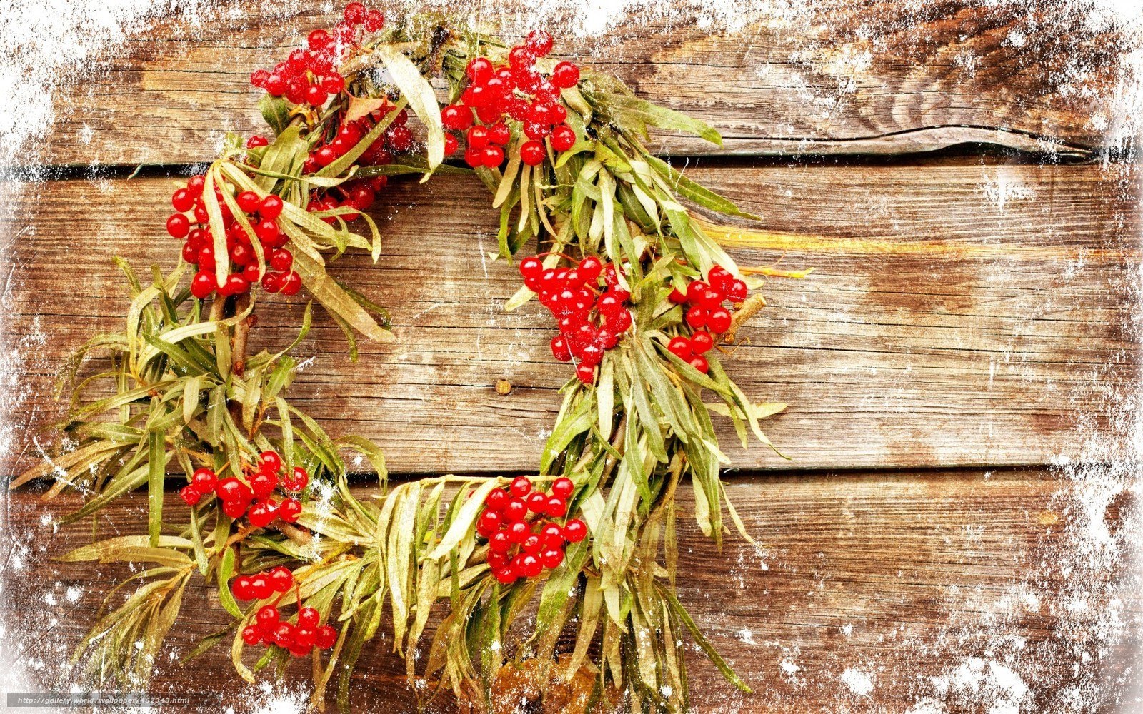 Red berry wreath on wood