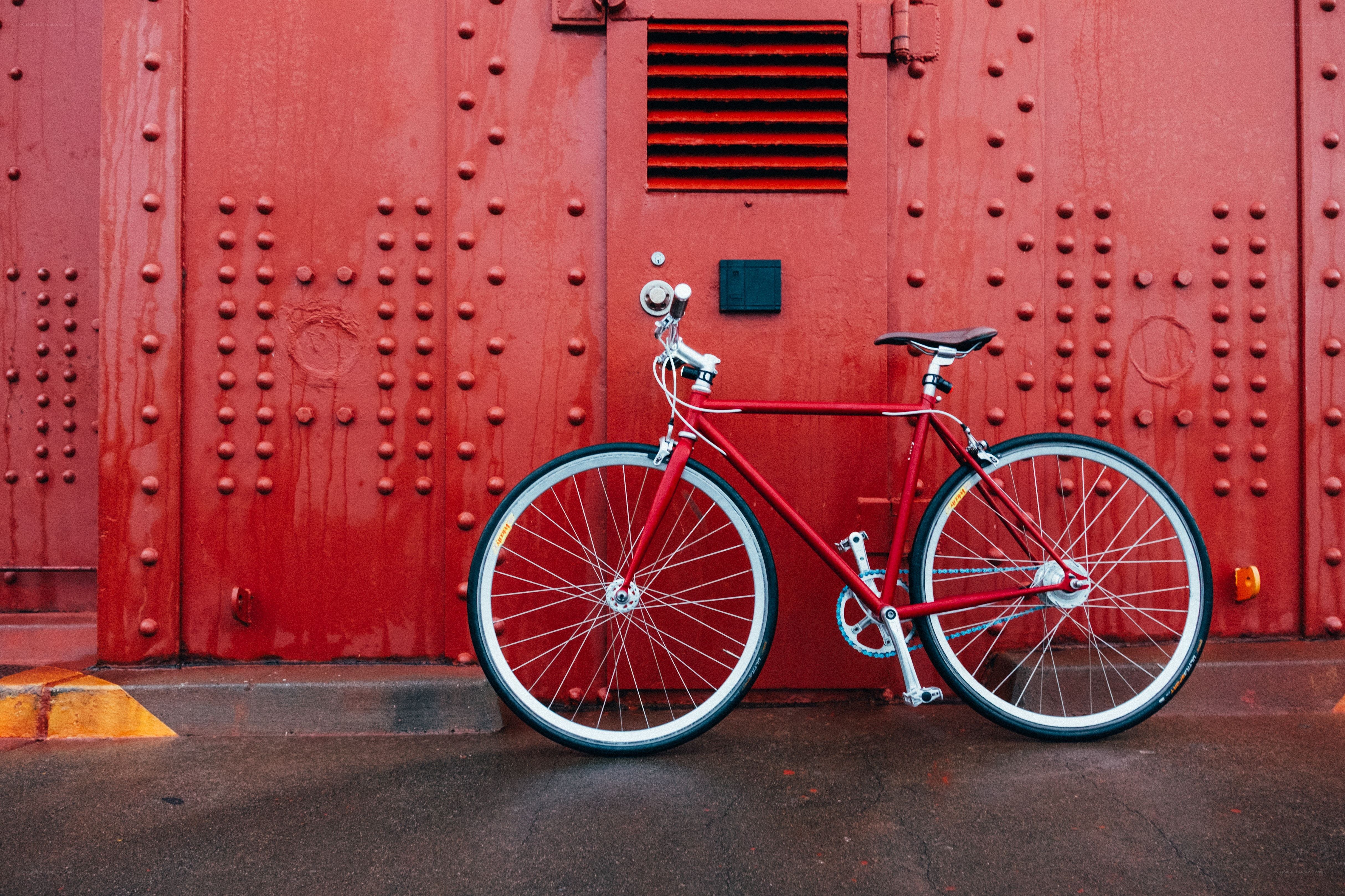 Red bicycle against red wall