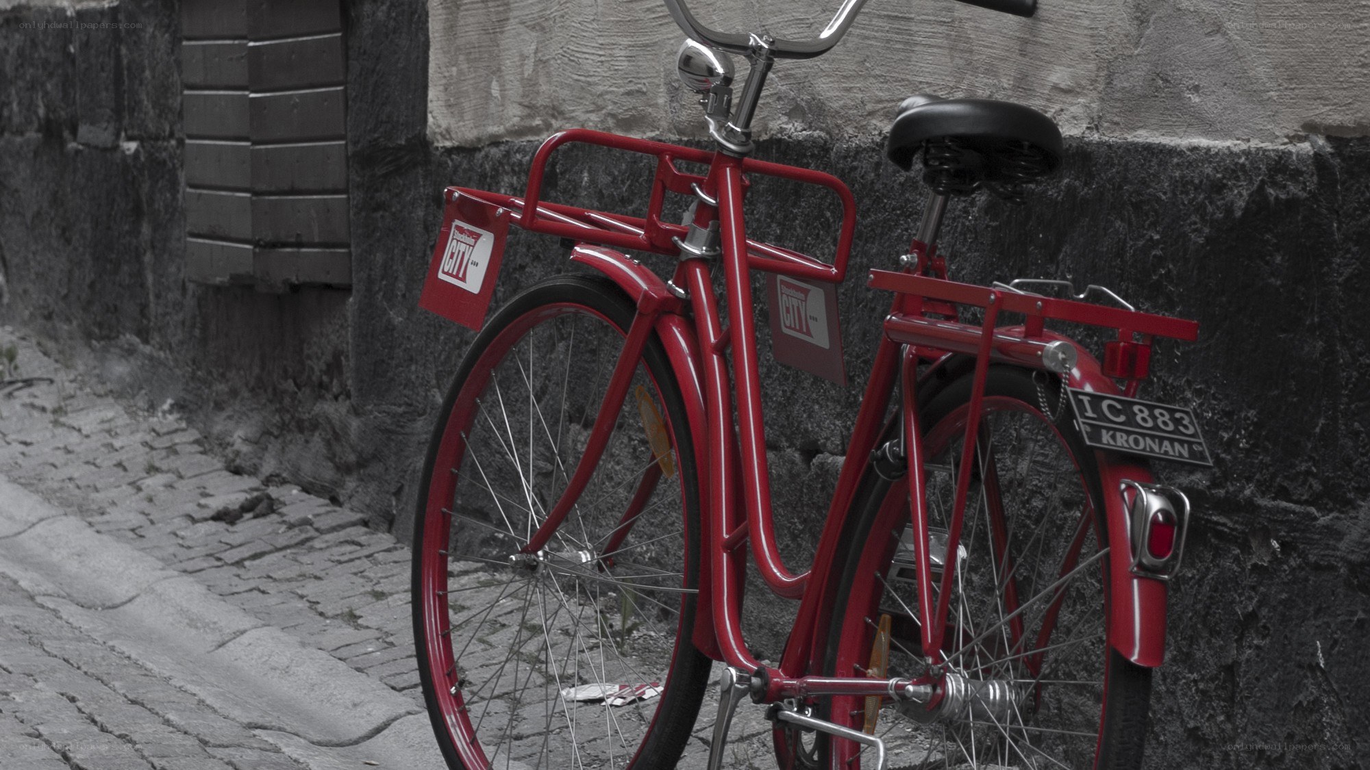 Red bicycle on cobblestone street