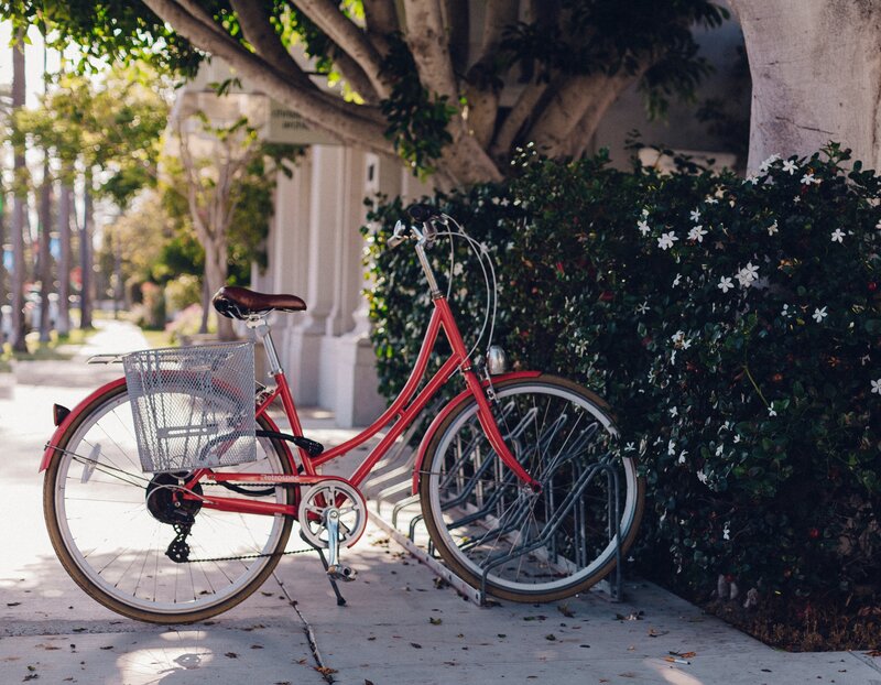 Red bicycle on sidewalk