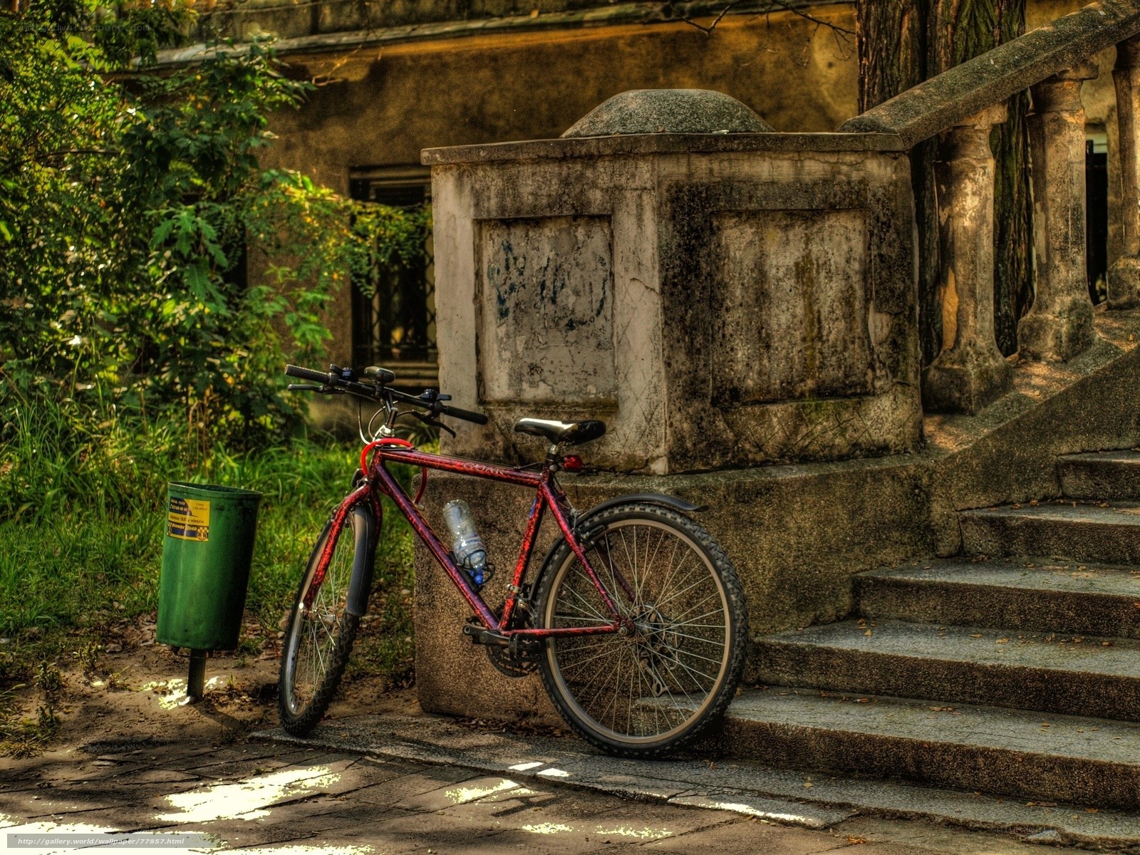 Red bike by stone steps