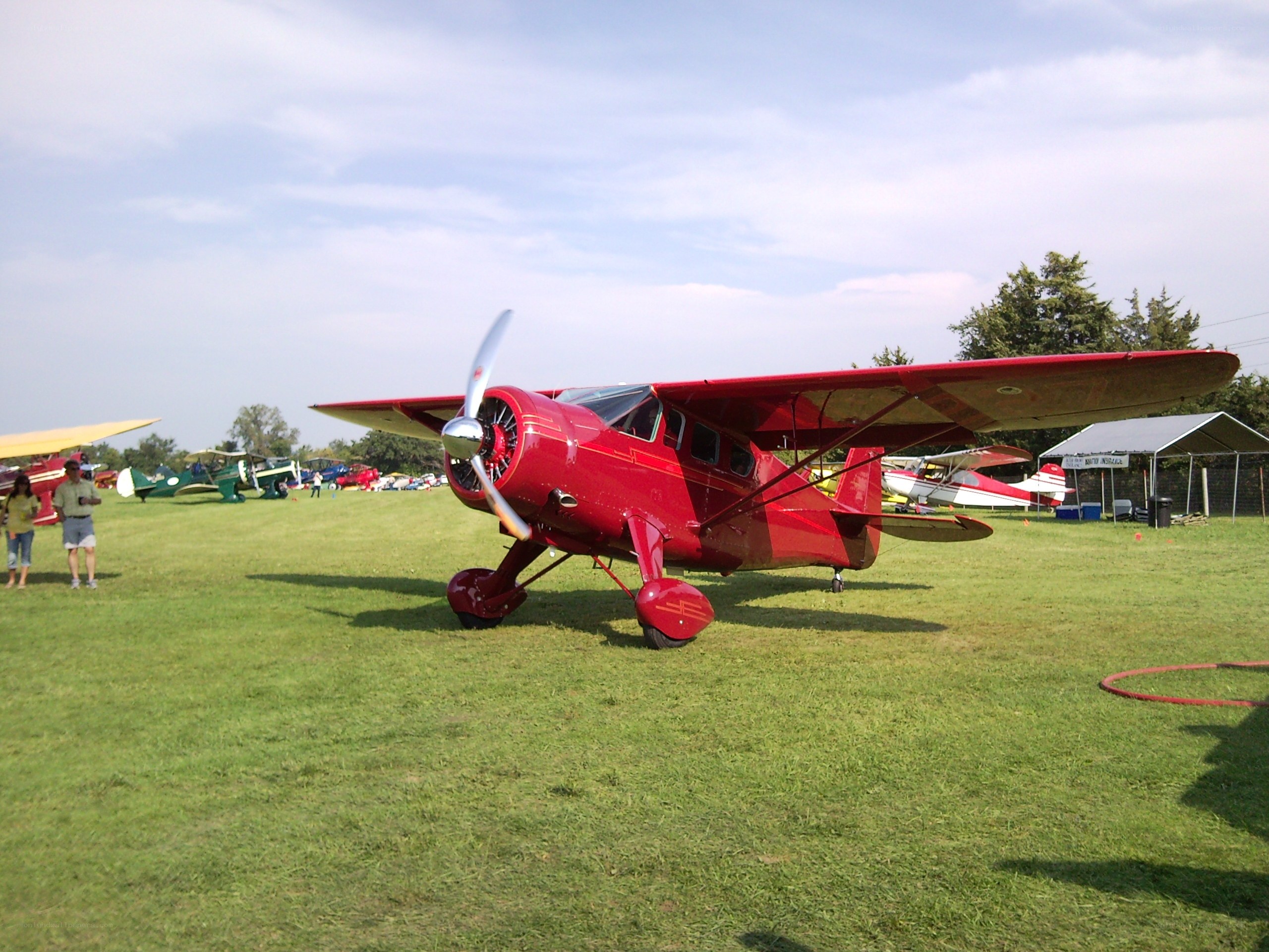 Red biplane at airfield