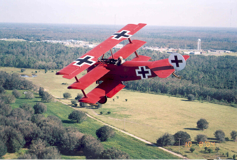 Red biplane in flight