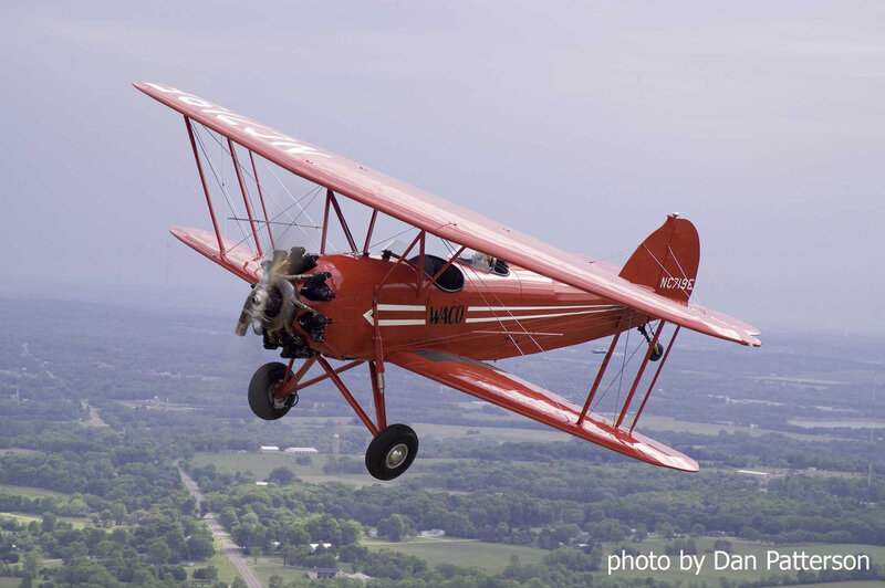 Red biplane in flight