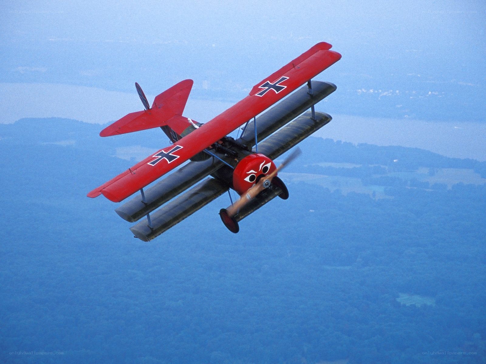 Red biplane in flight