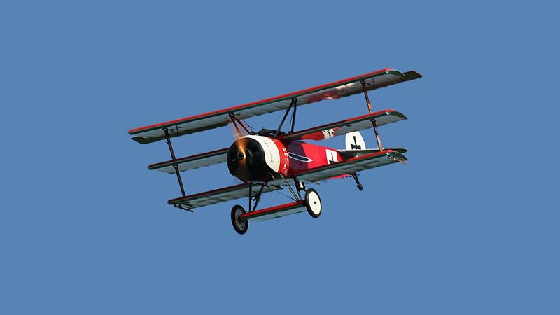 Red Biplane in Flight — Blue