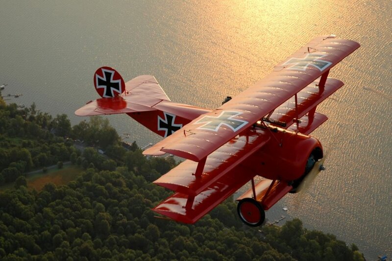 Red Biplane in Flight — Dramatic