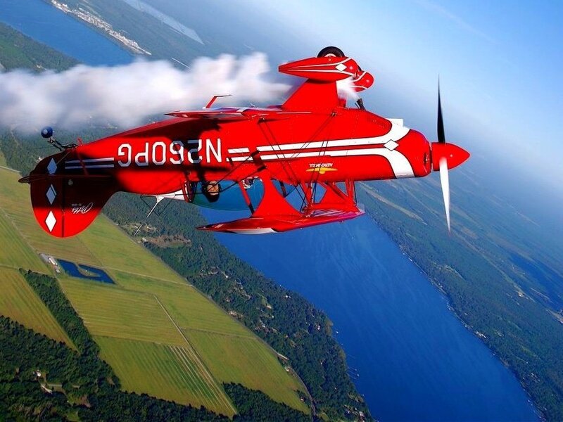 Red Biplane in Flight — Dynamic, Afternoon, Photograph, Aircraft, Lake