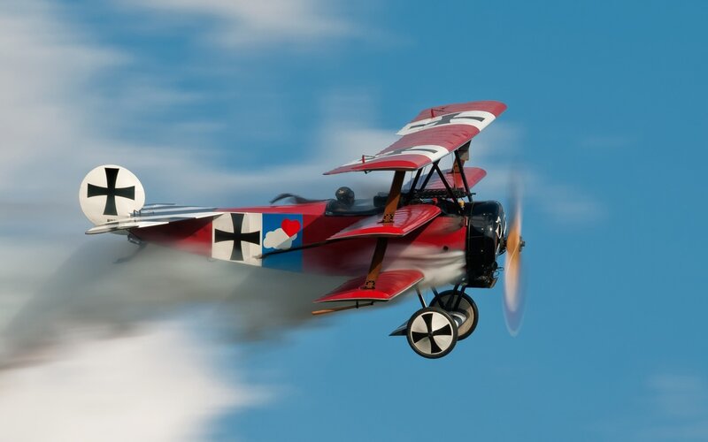 Red Biplane in Flight — Dynamic, Afternoon, Photograph, Propeller