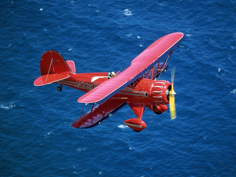 Red Biplane in Flight — Dynamic, Afternoon, Photograph
