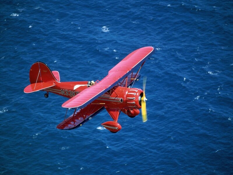 Red Biplane in Flight — Dynamic, Photograph