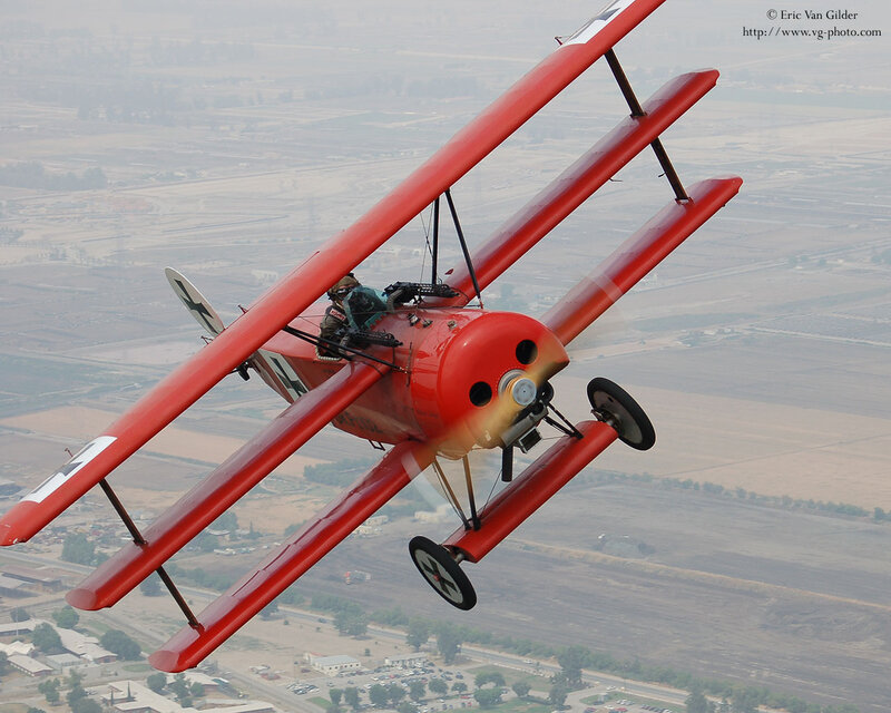 Red biplane in flight