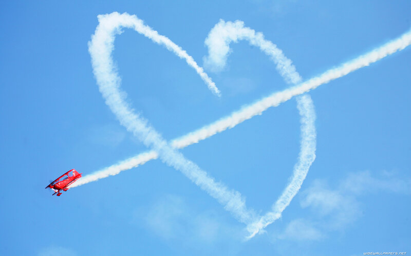 Red Biplane in Sky