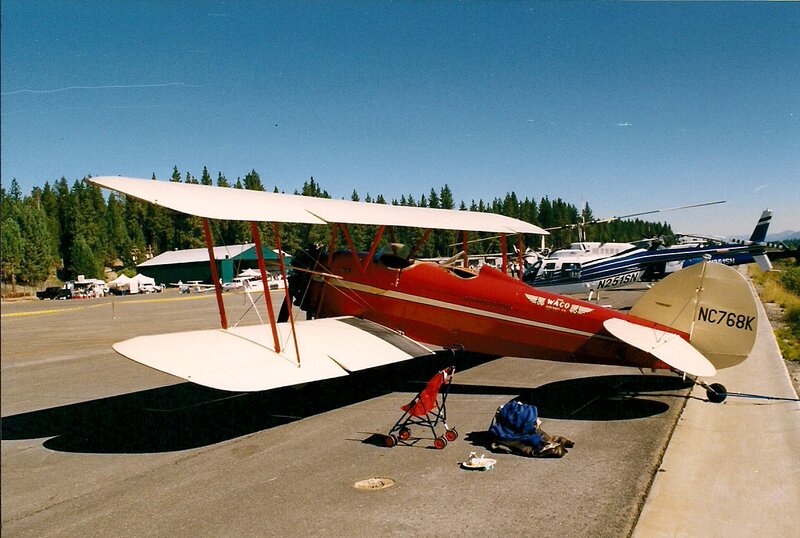 Red Biplane on Tarmac — Calm, Afternoon
