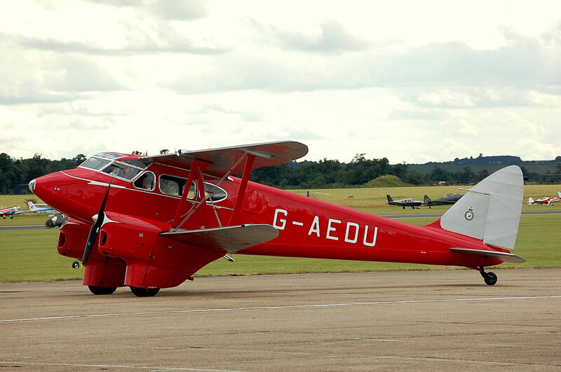 Red Biplane on Tarmac — Calm