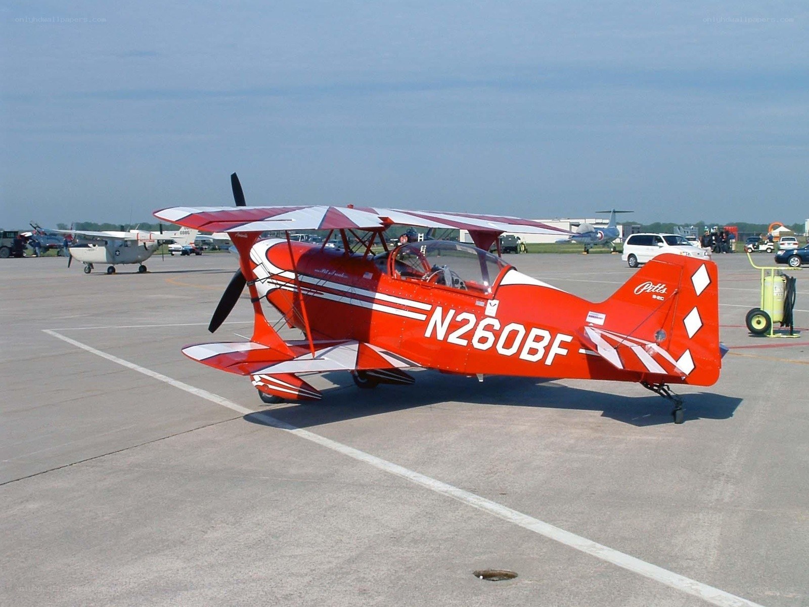 Red biplane on tarmac