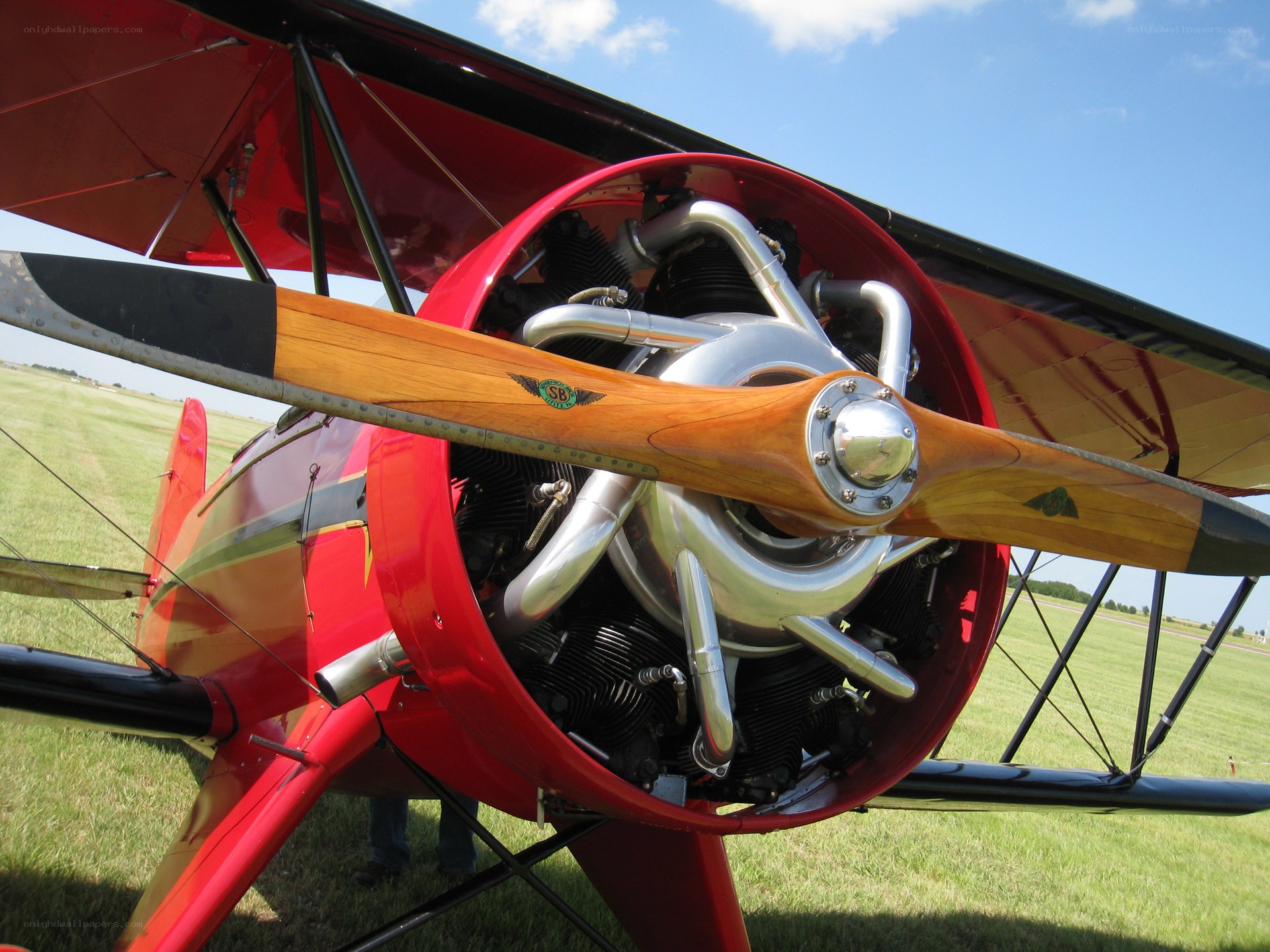 Red biplane with wooden propeller