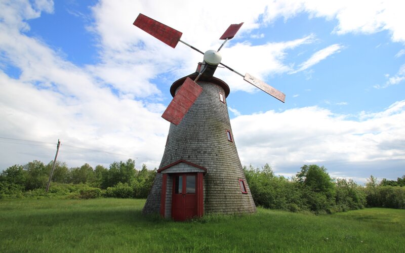 Red-bladed windmill in a field