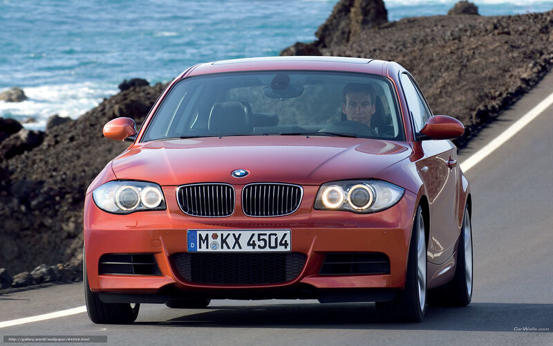 Red BMW 1-Series on coastal road