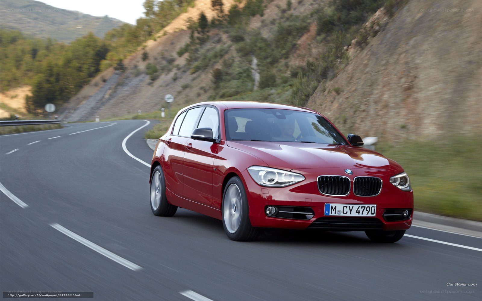 Red BMW 1 Series on winding road