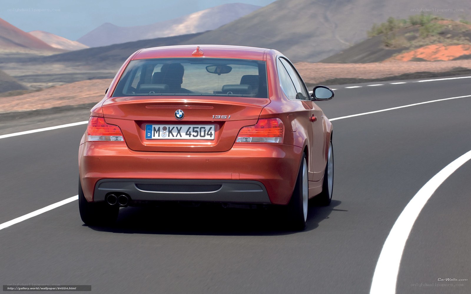 red bmw 135i on winding road