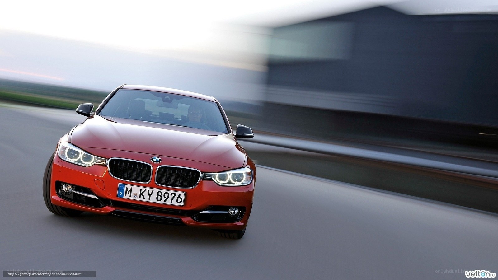 Red BMW 3 Series in motion