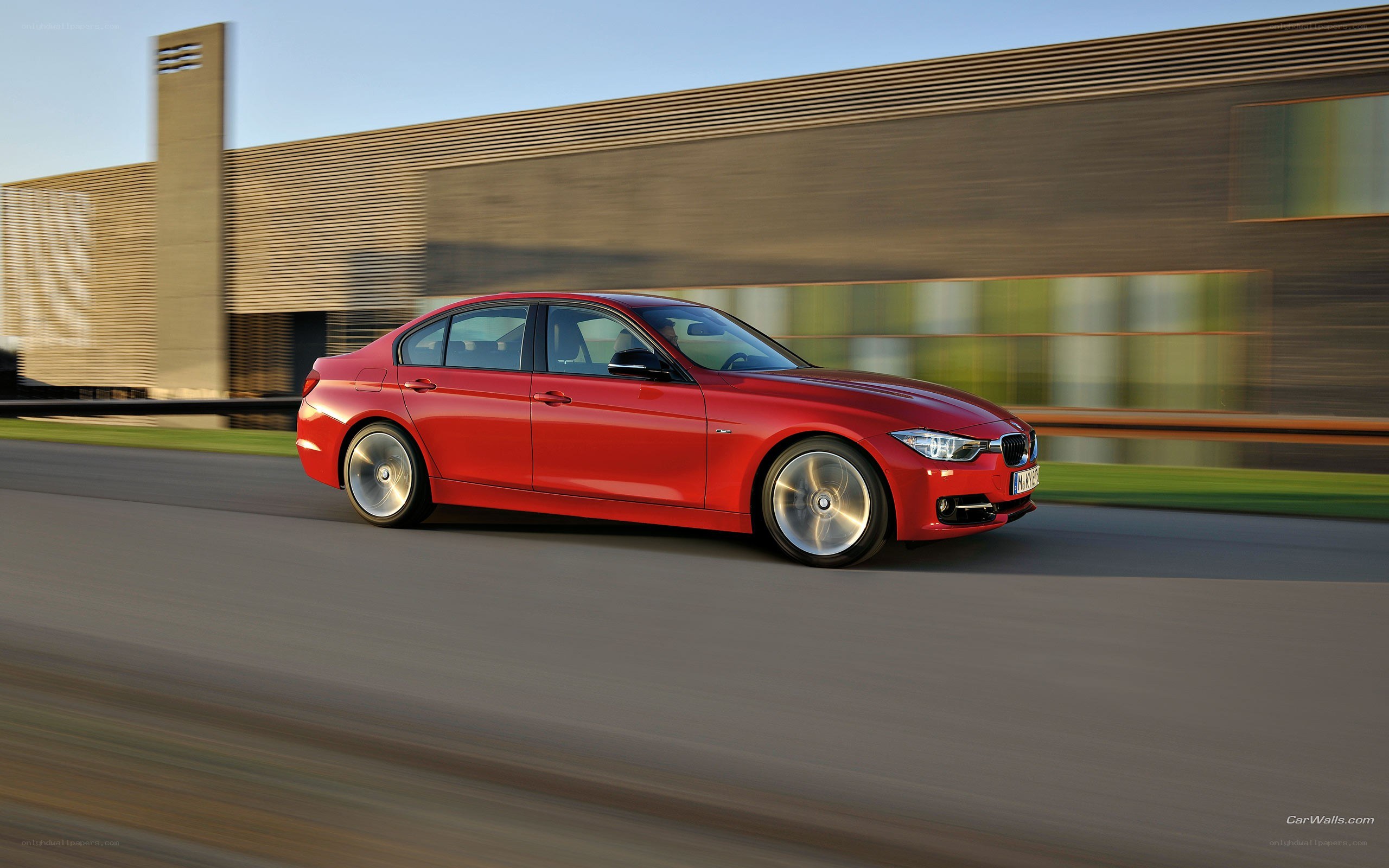 Red BMW 3 Series in motion