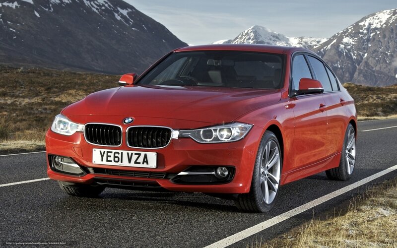 Red BMW 3 Series on mountain road